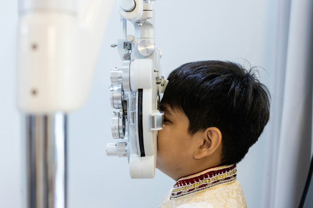 Close up asian Little boy eye exam with diagnostic ophthalmology in optical clinic.