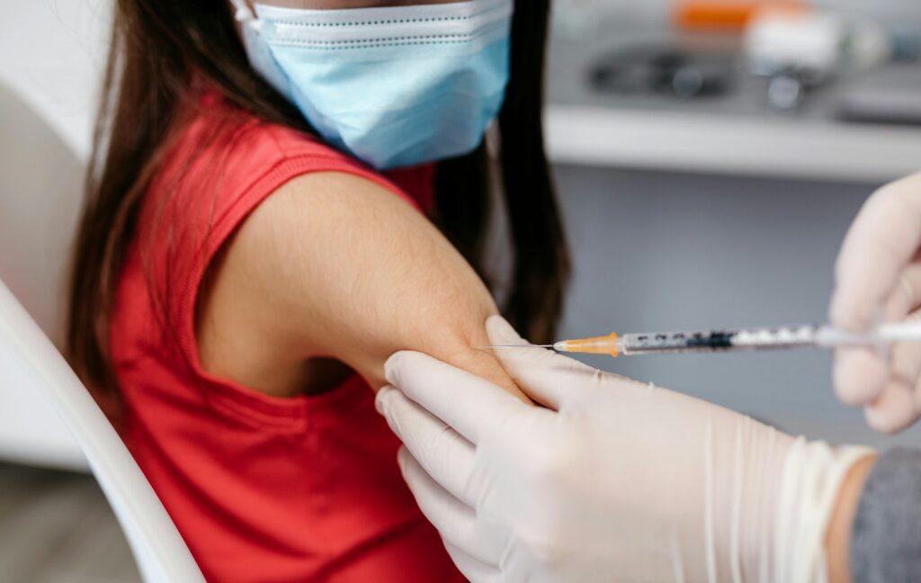 Closeup of girl receiving coronavirus vaccine at doctor's office