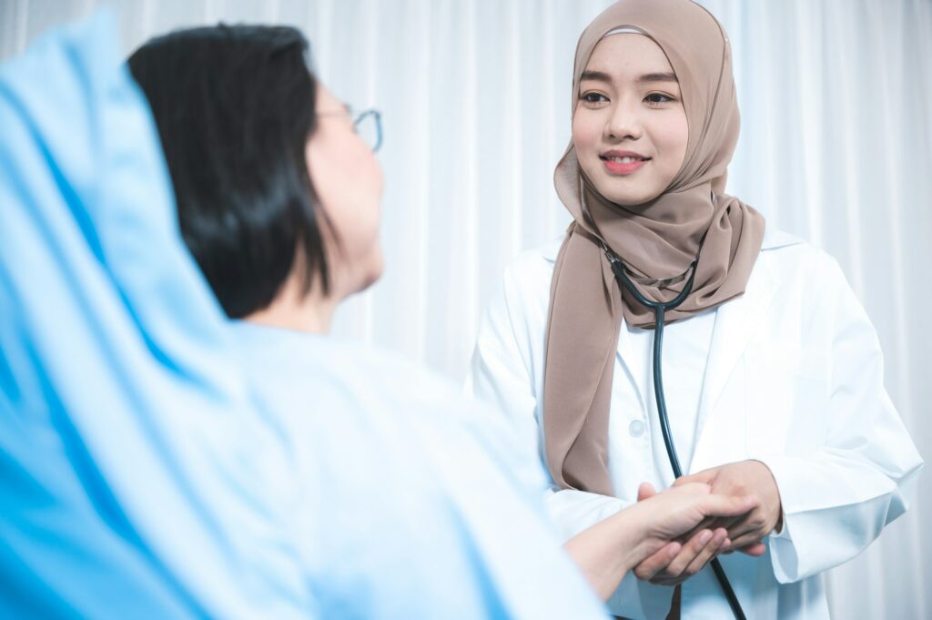 The beautiful Muslim doctor wear hijab works at the hospital to take care the elderly patient